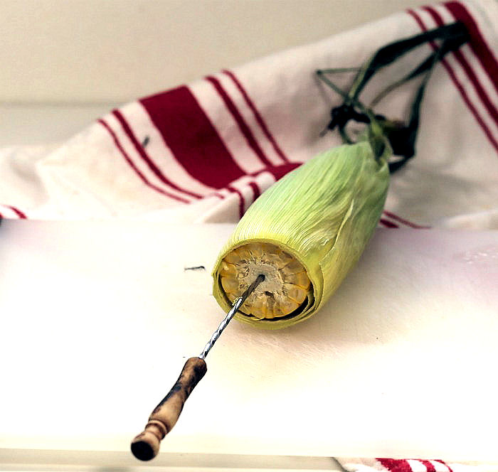 Barbecue skewer in ear of corn