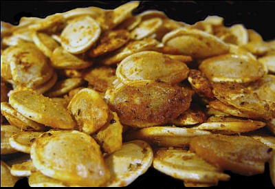 Roasted Pumpkin seeds are super easy to do and make a very healthy snack. It's a fun activity to do with kids after you are done carving the pumpkin! thegardeningcook.com