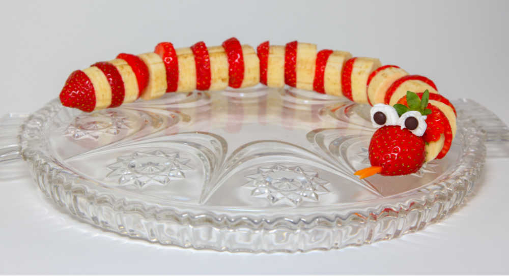 Strawberries and bananas combined with mini marshmallows and chocolate chips to make a snake.