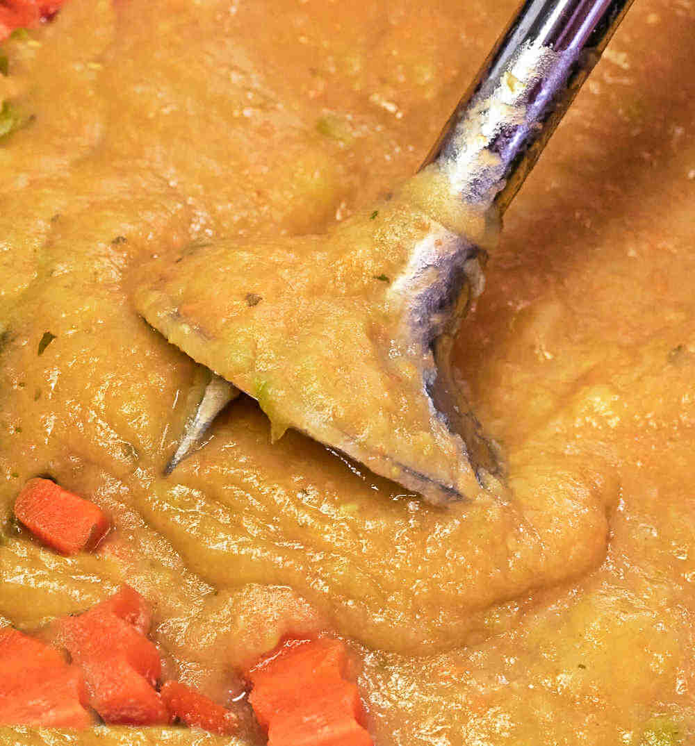 Blending soup with an immersion blender.
