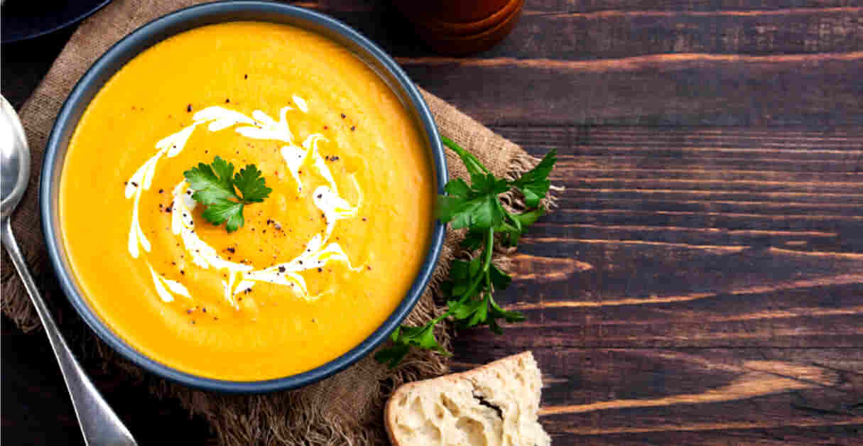 curried coup with creamy center and parsley in a bowl with some bread.
