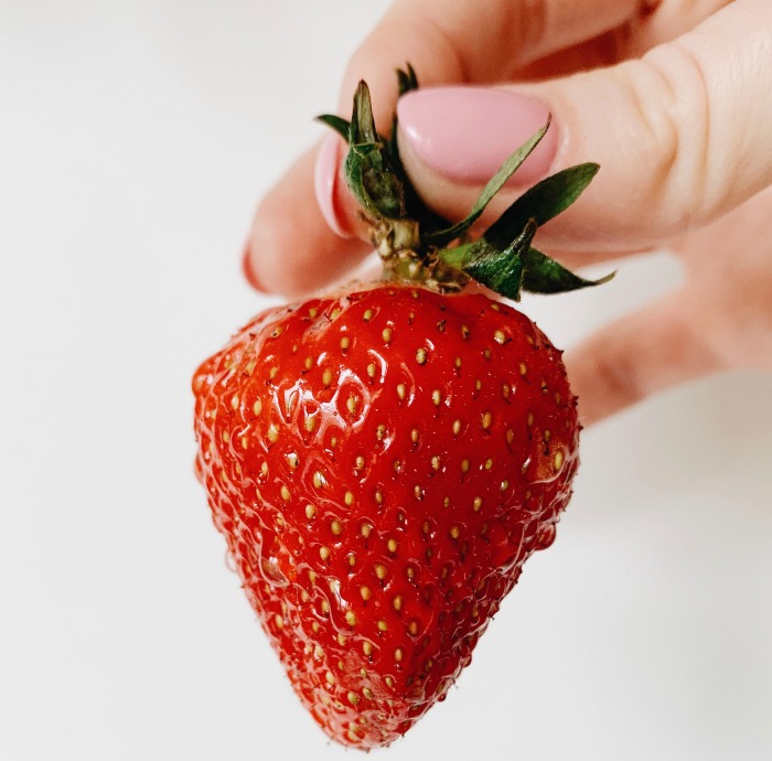 Holding a strawberry