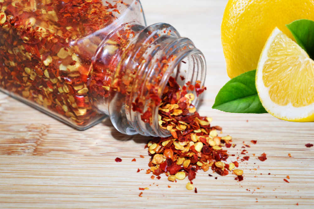 Jar of red pepper flakes and fresh lemons.