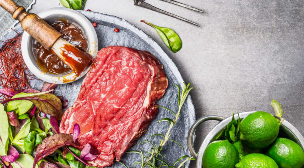 Mojo marinade with steak and limes.