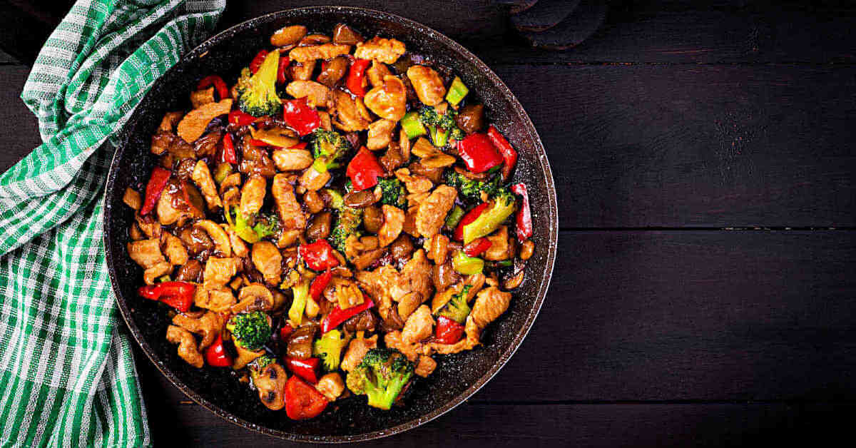 Thai peanut stir fry in a bowl with a towel.