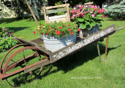 Wheel barrow planter with galvanized tubs and washtub ringer.