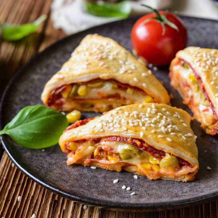 Pizza rolls with basil and tomatoes.