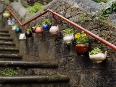 Teapots as planters and hung on rails. Great street art.