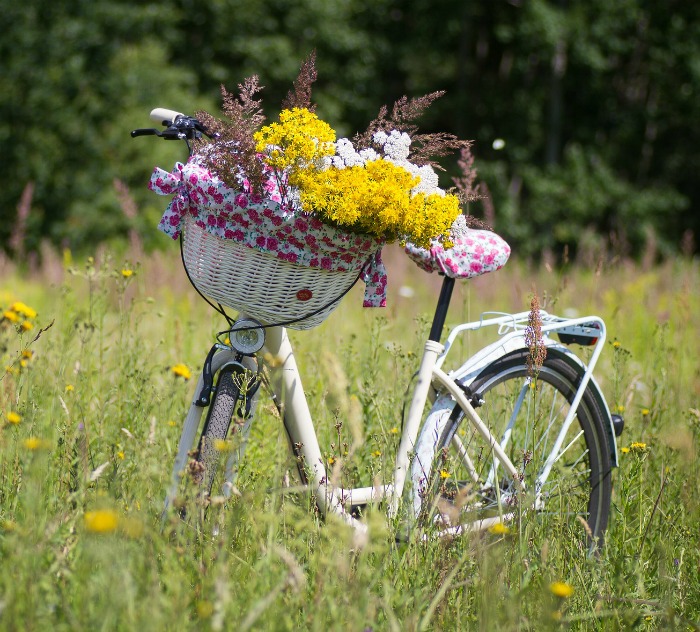 White Bicycle Planter with basket of wildflowers Bicycle Planter with wild flowers