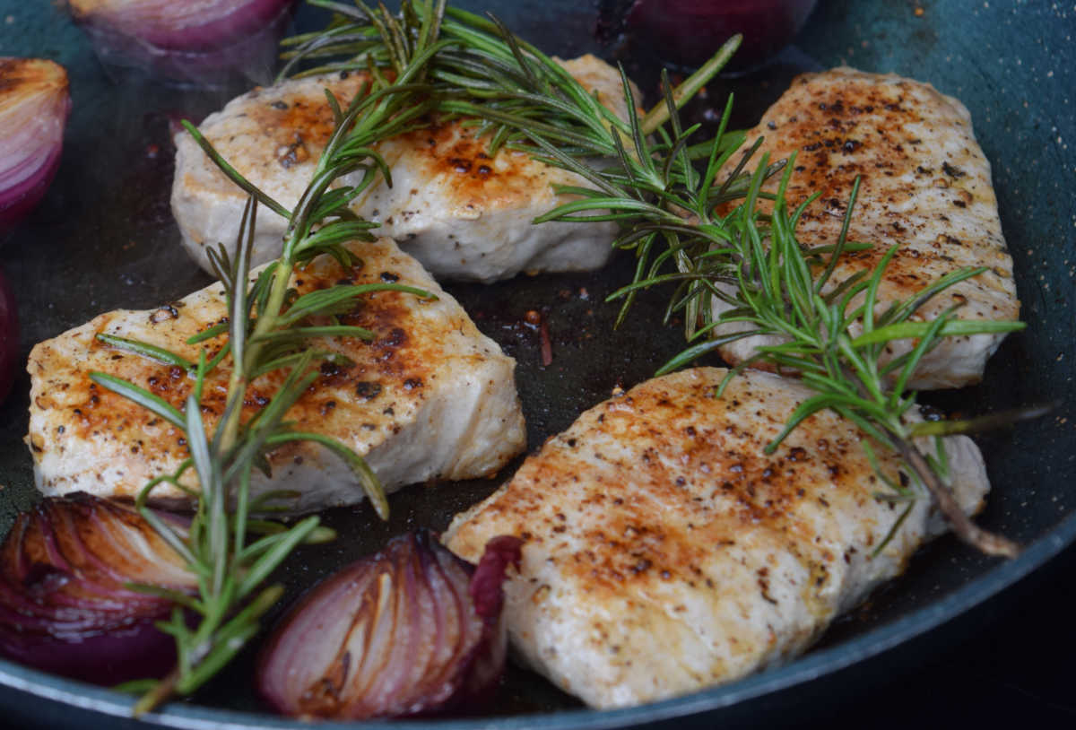 Grilled pork chops with onions and rosemary.