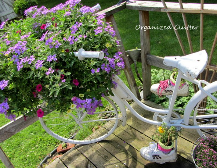 Ghost planter with baby shows and white bicycle White bicycle planter