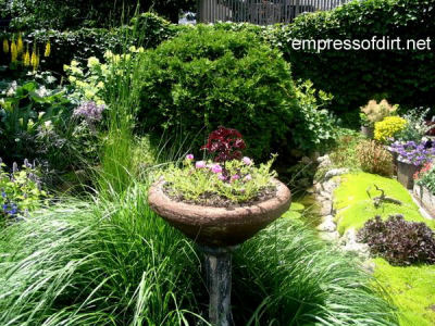 Cracked bird bath recycled as a planter
