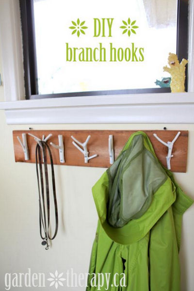 Garden twigs painted white make a great coat hook display.
