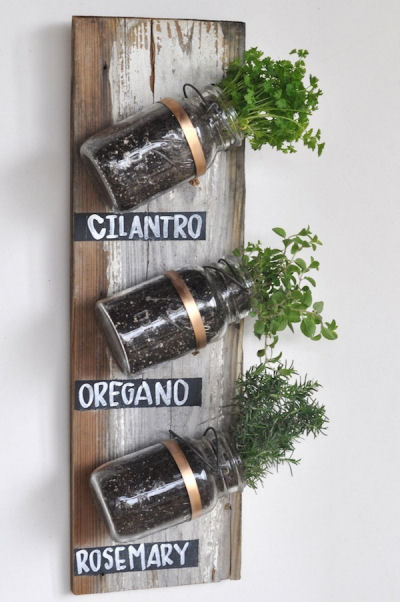 Mason Jars and herbs on an old board. Great kitchen wall decoration.