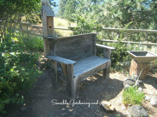 Wooden garden bed with built in bird house.
