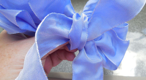 Floral bow bring end through