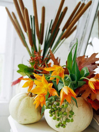 White Faux pumpkin used as a vase for cat's tails and fall greenery and flowers