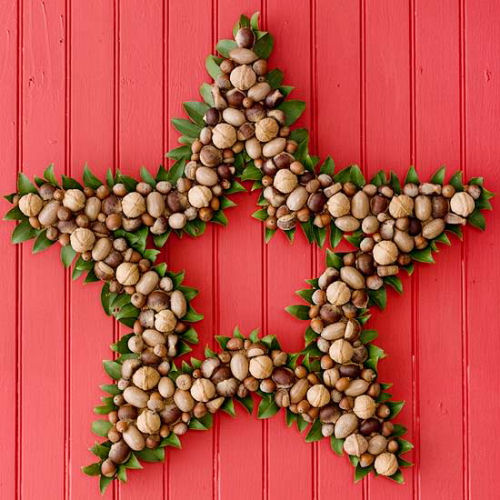 Star shaped Nut Christmas wreath from bhg.com on a red wall.