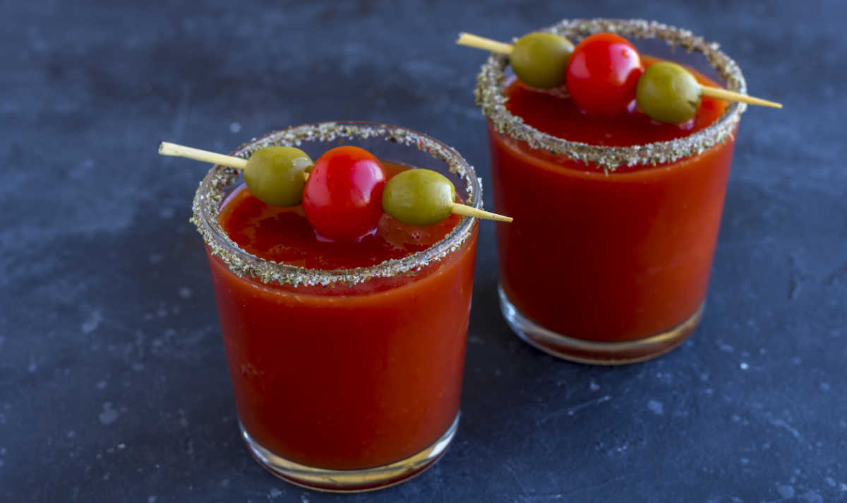 Bloody Mary drinks with olives and salt on rims.