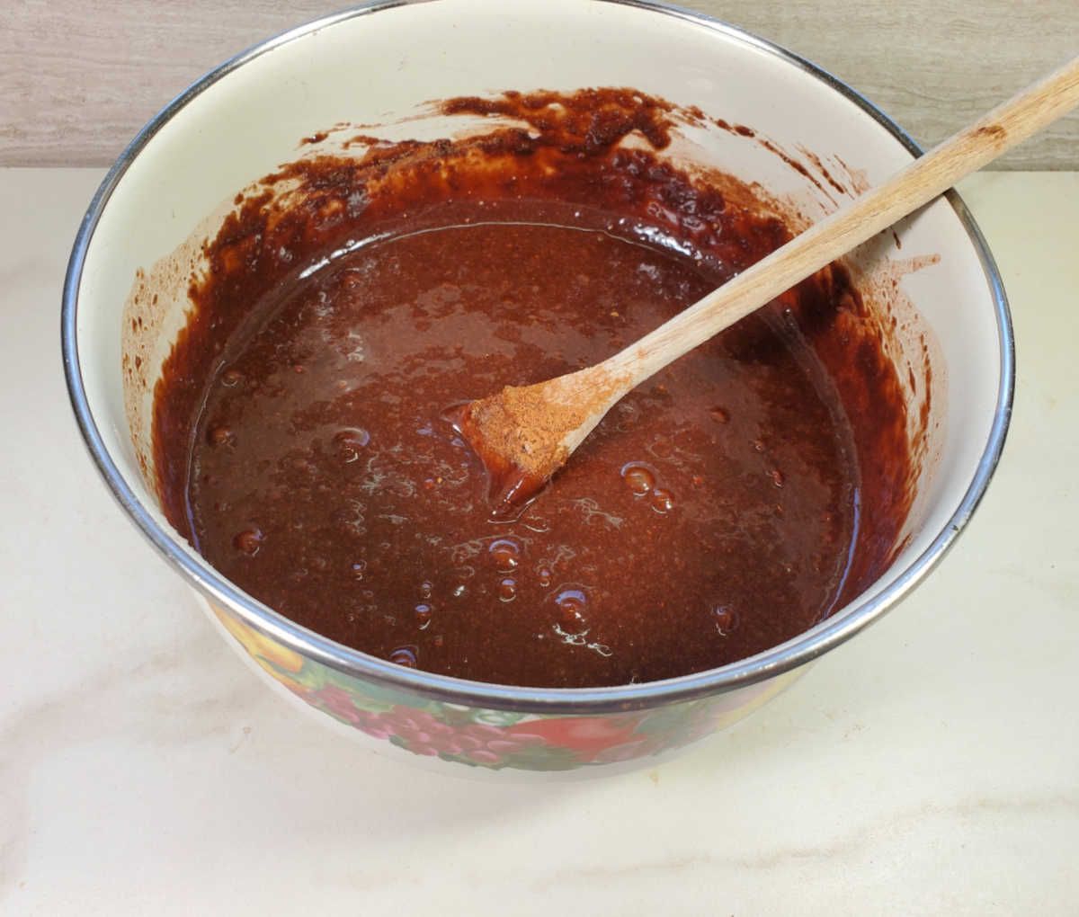 Brownie mix in a bowl with a wooden spoon.