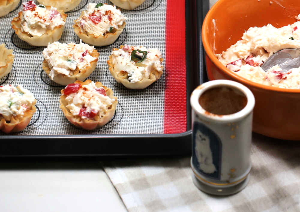 Phyllo cup crab appetizers garnished with paprika.