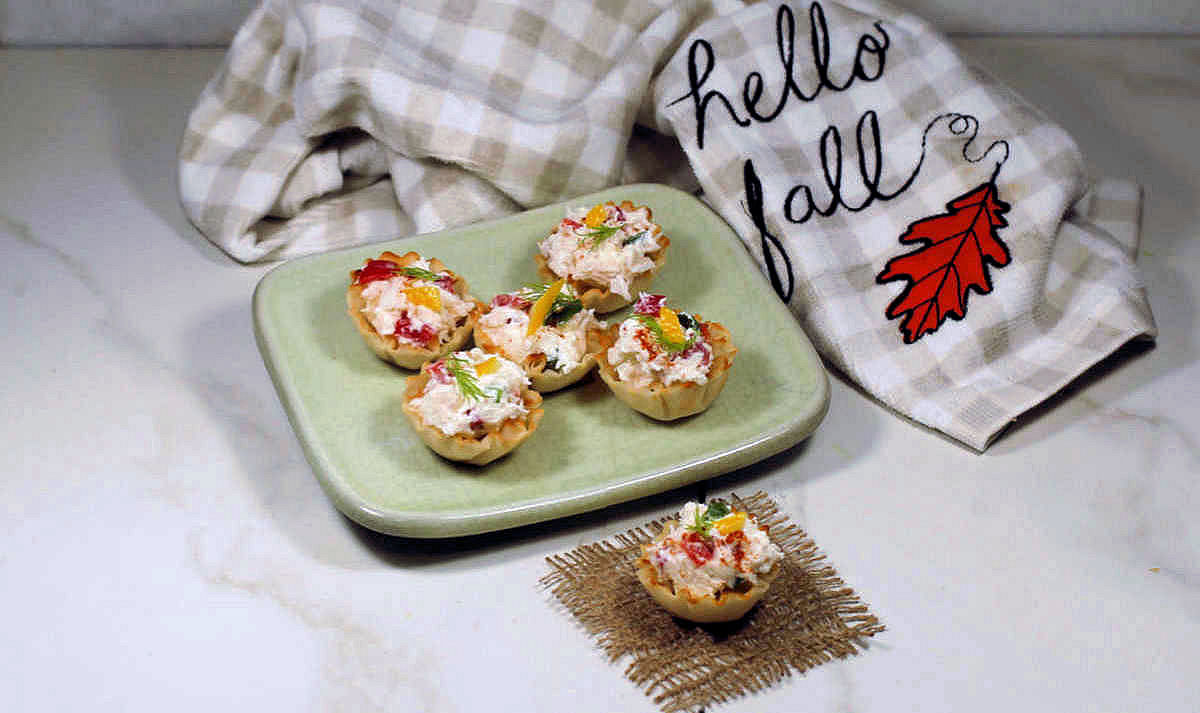 Phyllo cup recipe with crab and a tea towel that says Hello Fall.