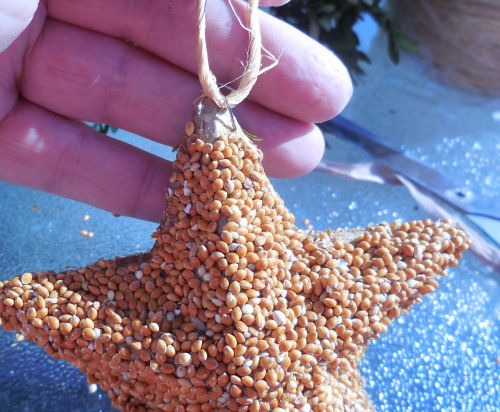 Floral pin with twine goes into the bird seed ornament.
