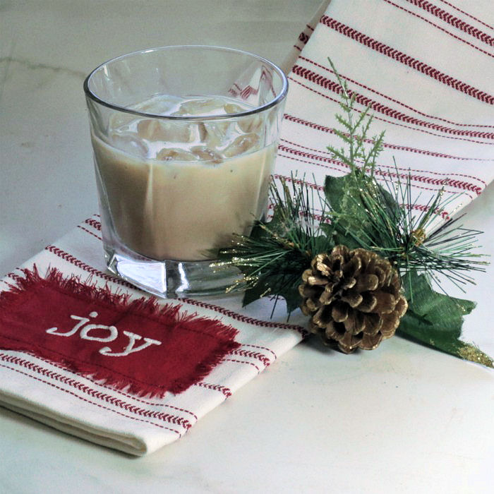Bailey's Mudslide cocktail over ice with pine cone and joy towel.