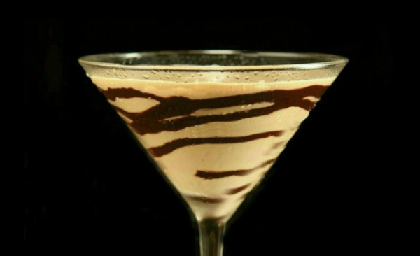 Chocolate drizzled martini glass with Bailey's mudslide cocktail in it.