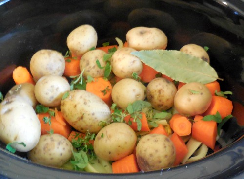 slow cooker pot roast vegetables seasoned with fresh herbs