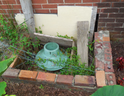 My husband's idea of how to close a crawl space opening.