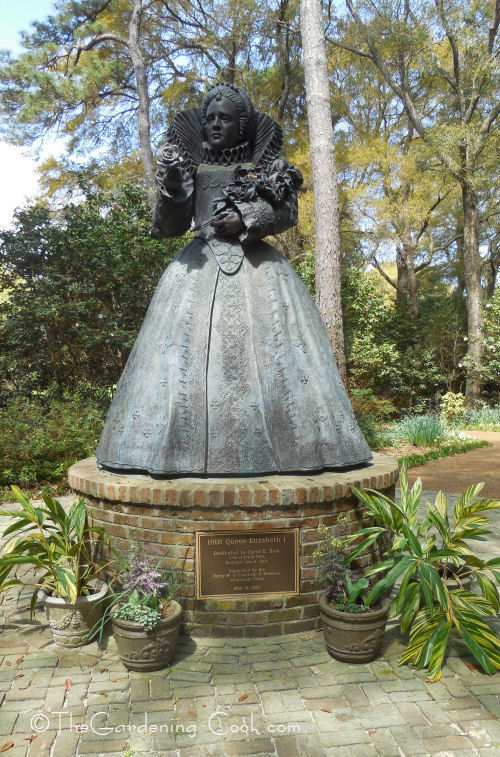 Queen Elizabeth I stands at the beginning of the garden paths.