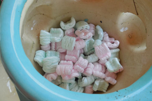 Packing peanuts in a pot mean that you use less soil and the planter is lighter too.