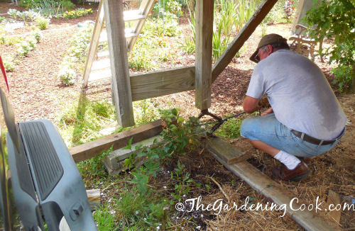 Raising the playhouse with a jack.