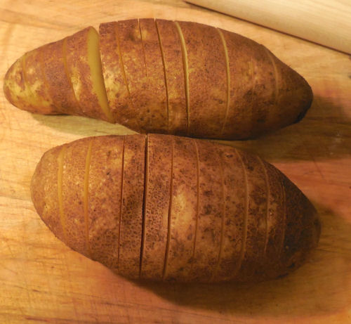 Slice the potatoes almost through
