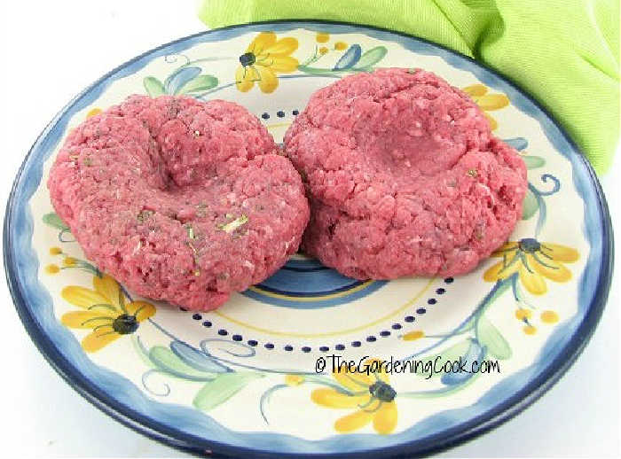 Burgers with indentation on a plate.