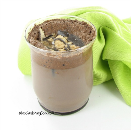 Cookies and cream coffee flavored chocolate milk in a glass with a green napkin.
