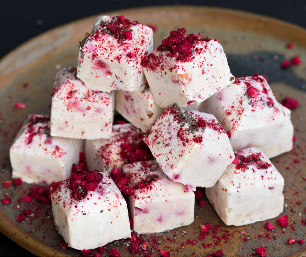 Frozen yogurt cubes with pomegranate toppings.
