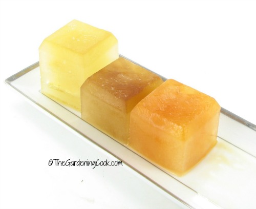 Veggie stock, chicken stock and beef stock cubes on a white plate.
