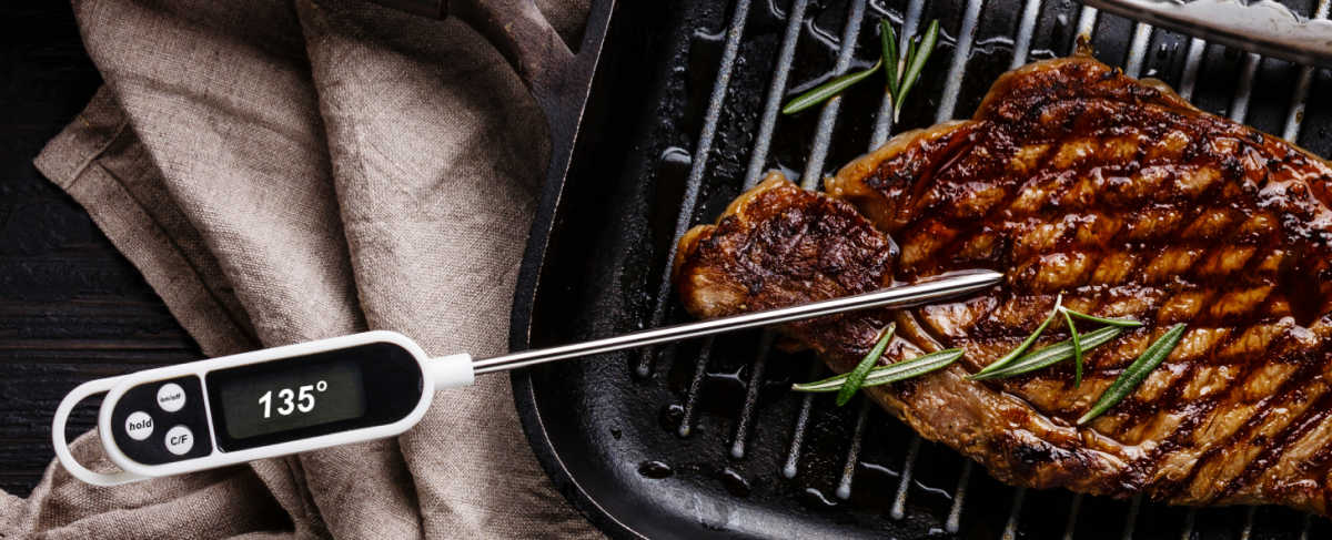 Testing meat with a thermometer.