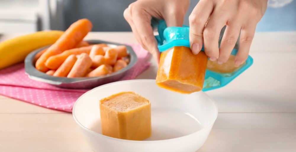 hands releasing food from silicone ice cube trays.