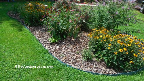 Use curved edges to add softness to a cottage garden