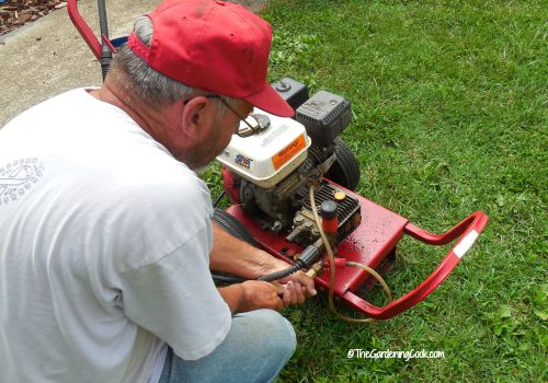 man checking a power washer.