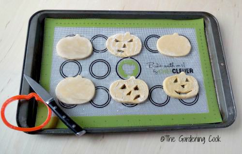 Halloween pumpkin cookies on silicone mat