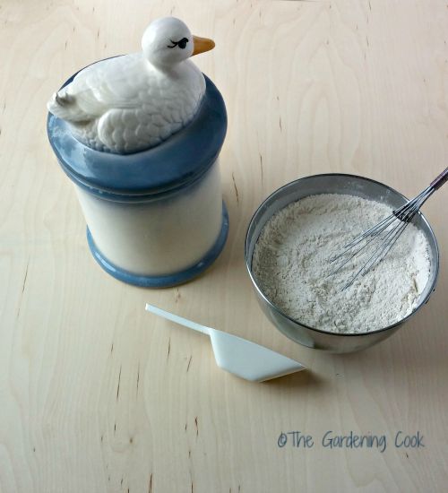 Cannister with duck, bowl of flour and scoop.