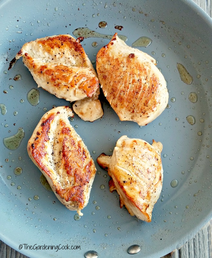 cooked chicken breasts ready for sauce