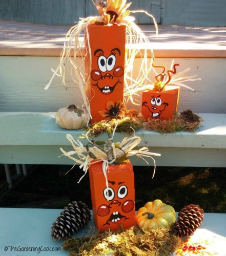 Scrap wood pumpkins with moss and pine cones