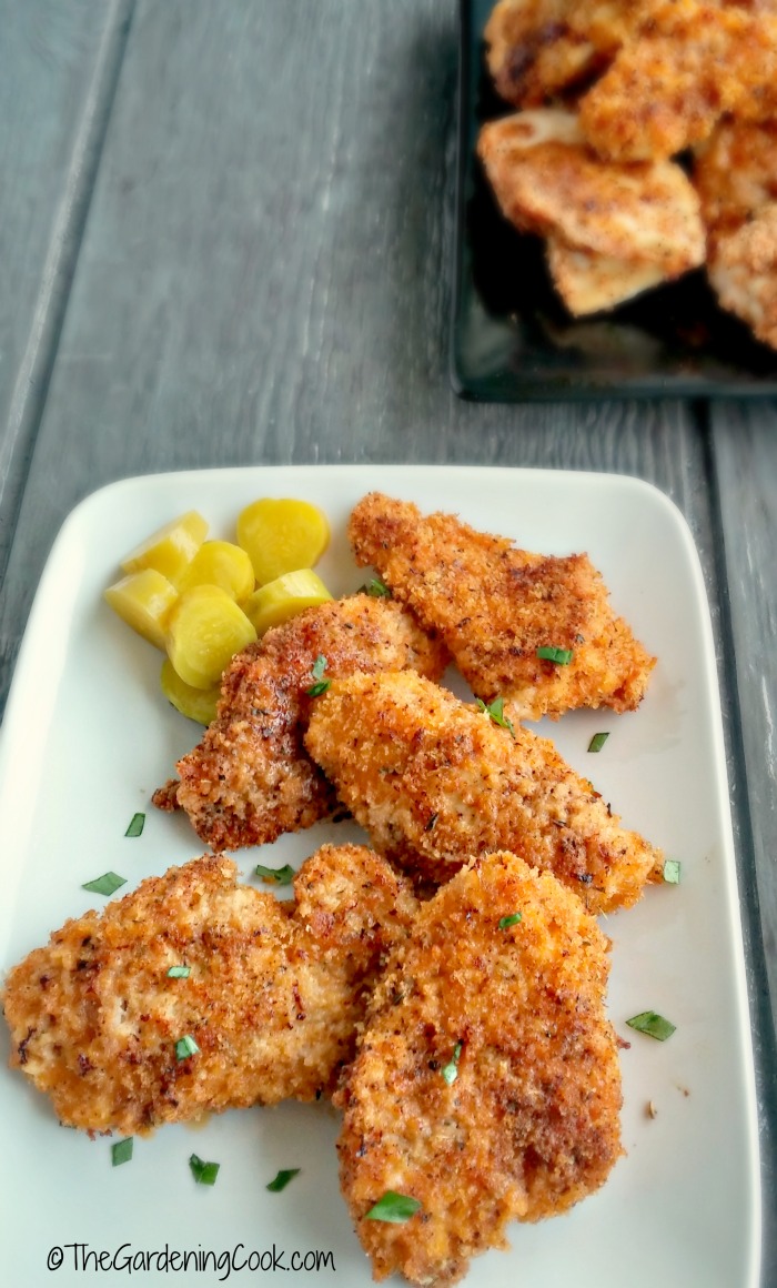 copycat KFC oven fried chicken pieces on a white plte with potatoes.