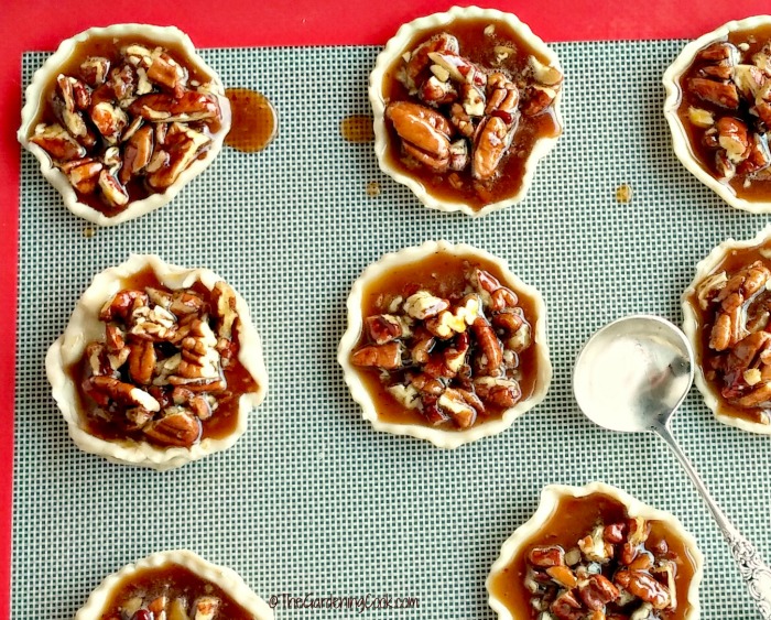 Cookie dough on a silicone mat with pecan pie filling.