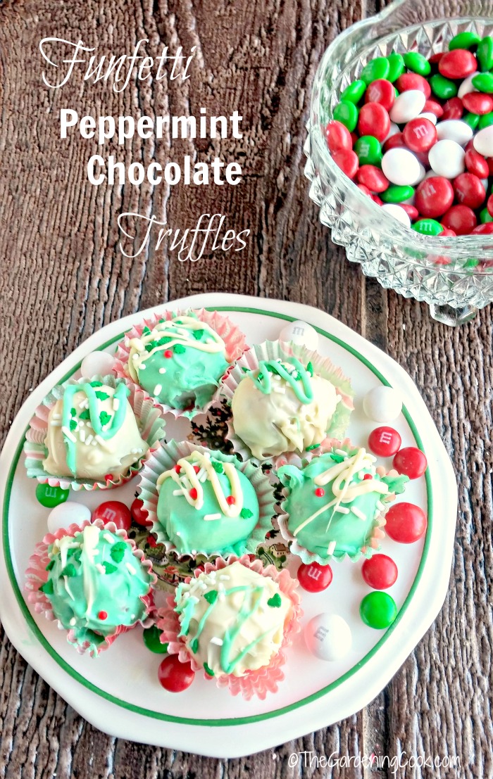 Festive truffles in wrappers on a plate near a bowl of MMs with words Funfetti Peppermint Chocolate Truffles.